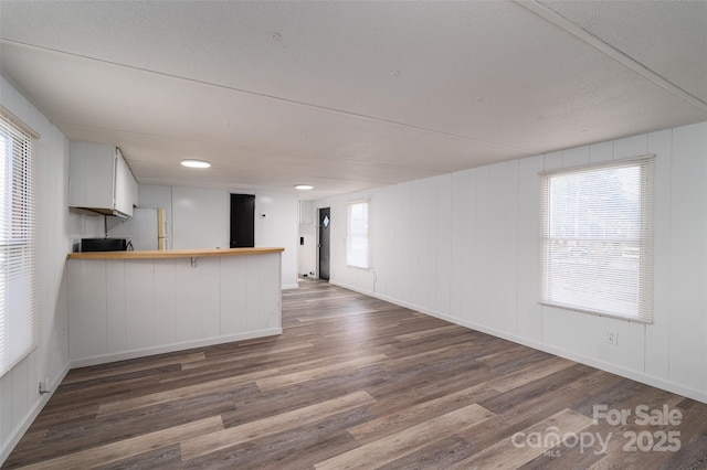 unfurnished living room featuring wood finished floors