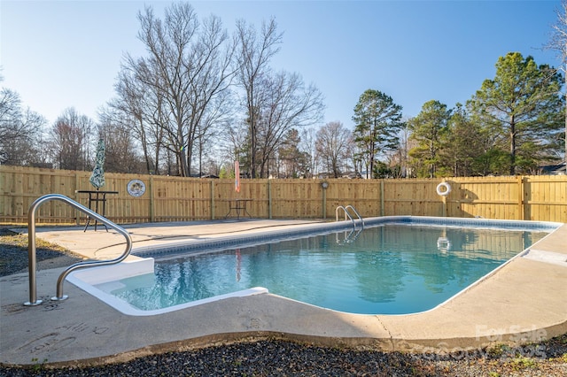 view of swimming pool with a fenced in pool and a fenced backyard