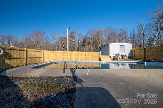 view of pool with a patio area, a fenced backyard, and a fenced in pool