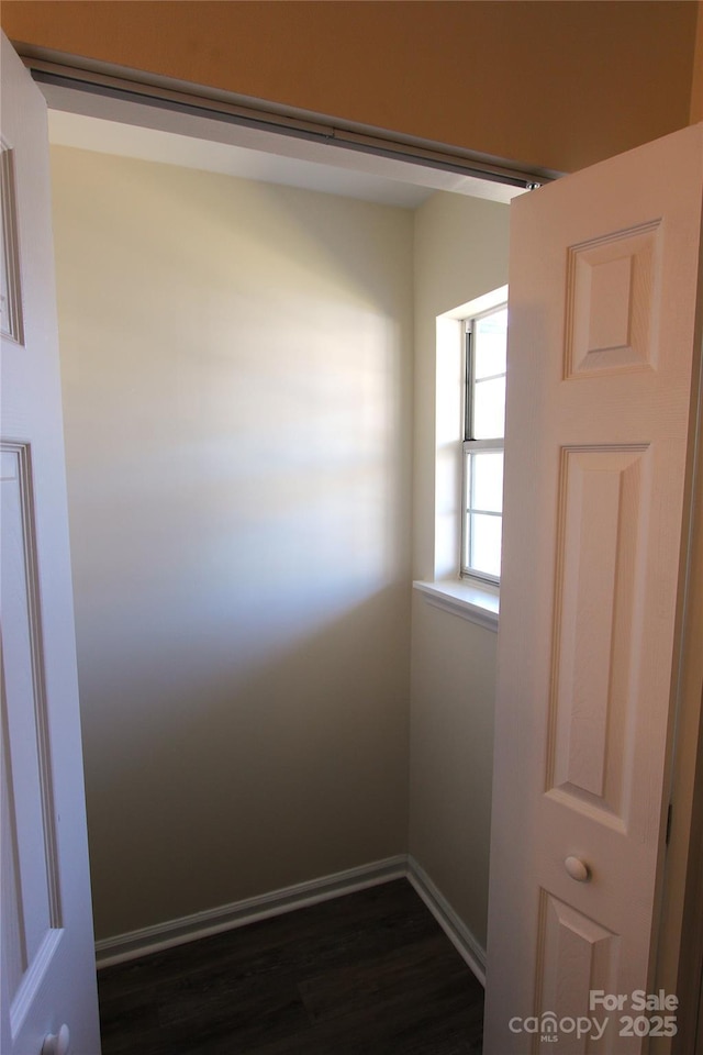 unfurnished room featuring dark wood finished floors and baseboards