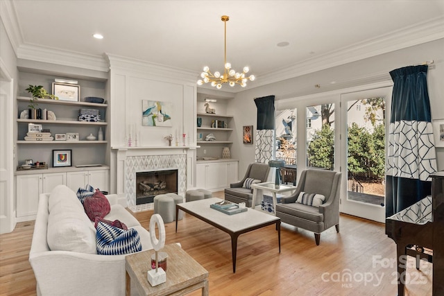 living area with ornamental molding, a fireplace, and light wood-style flooring