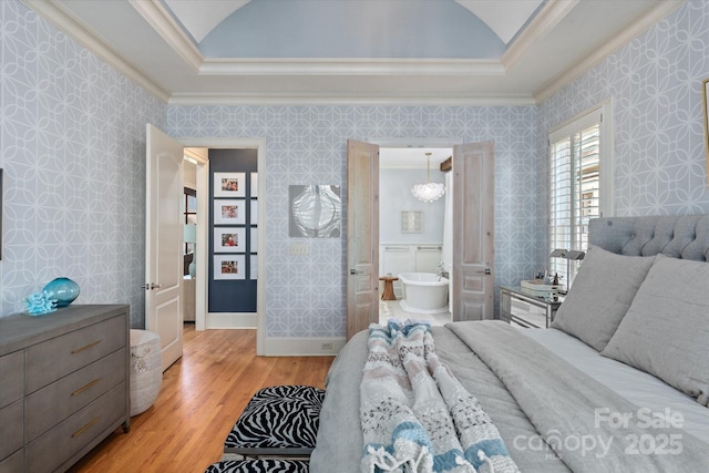 bedroom featuring crown molding, light wood-style flooring, and wallpapered walls