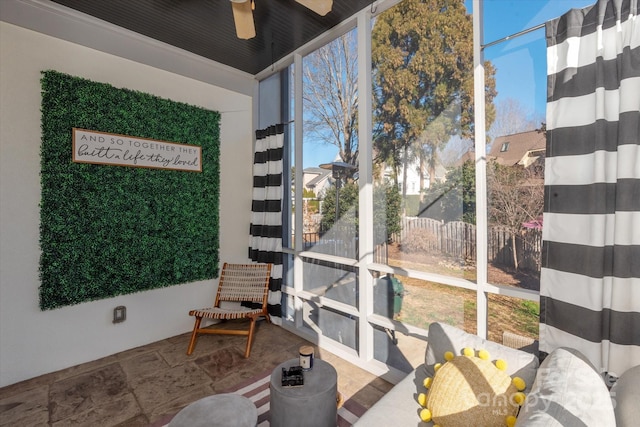 sunroom / solarium with ceiling fan and plenty of natural light