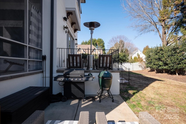 view of patio with fence and area for grilling