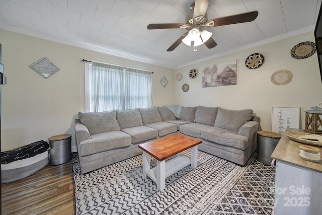 living room with ceiling fan, crown molding, and wood finished floors