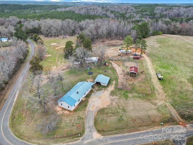 drone / aerial view featuring a view of trees