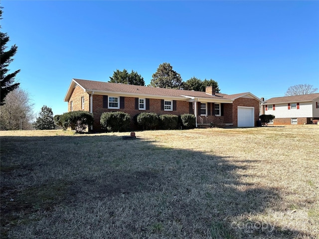 single story home with brick siding, a chimney, an attached garage, and a front lawn