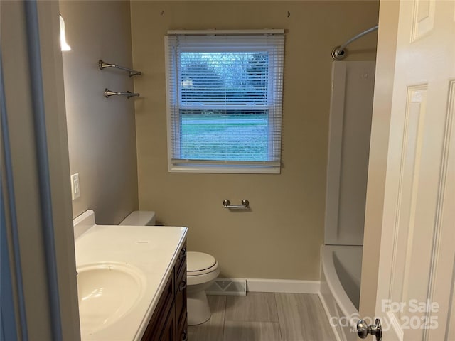 bathroom with toilet, baseboards, visible vents, and vanity