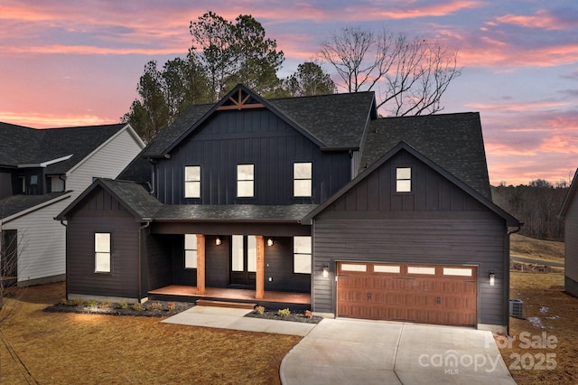 modern farmhouse style home featuring concrete driveway, a porch, an attached garage, a front lawn, and board and batten siding