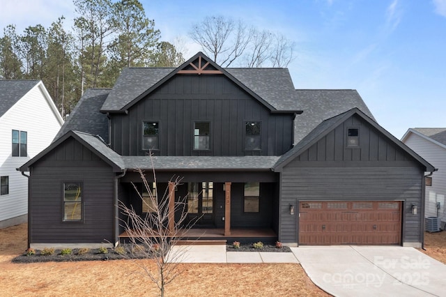 view of front facade with covered porch, concrete driveway, board and batten siding, and a garage