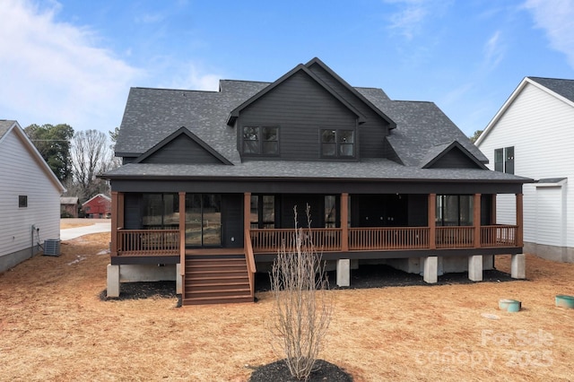 view of front of property featuring a shingled roof, cooling unit, and stairs