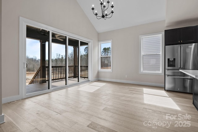 interior space with dark cabinets, light countertops, light wood-style floors, and high end refrigerator