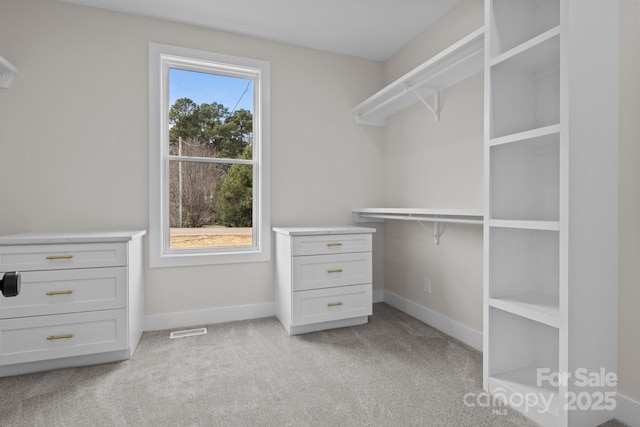 spacious closet featuring light carpet and visible vents