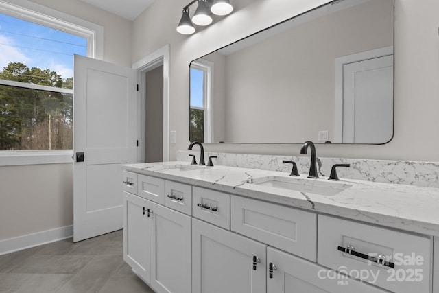 bathroom featuring plenty of natural light, a sink, and double vanity