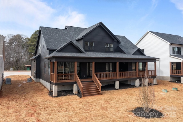 view of front of home featuring covered porch, roof with shingles, and stairs