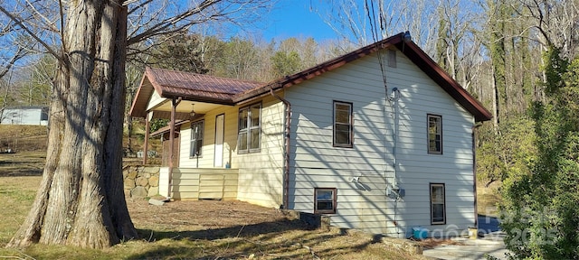 view of side of home with metal roof