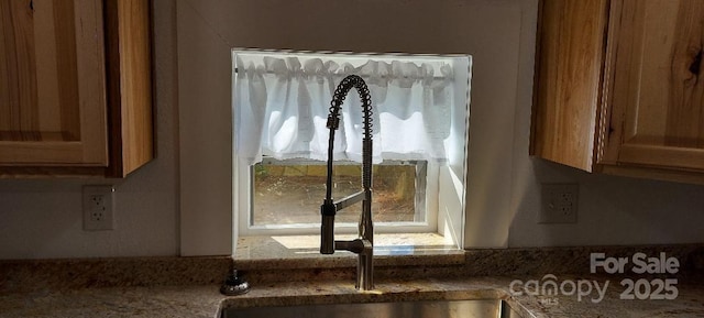 details featuring stone countertops and brown cabinetry