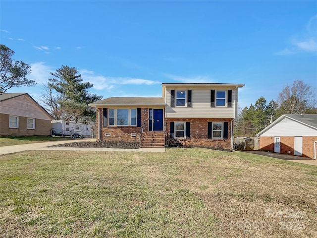 split level home with brick siding and a front lawn