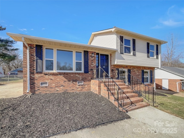 tri-level home with crawl space and brick siding