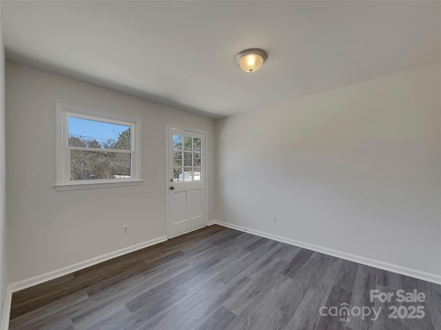 interior space featuring dark wood finished floors and baseboards