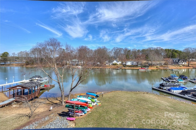 dock area with a water view and a yard