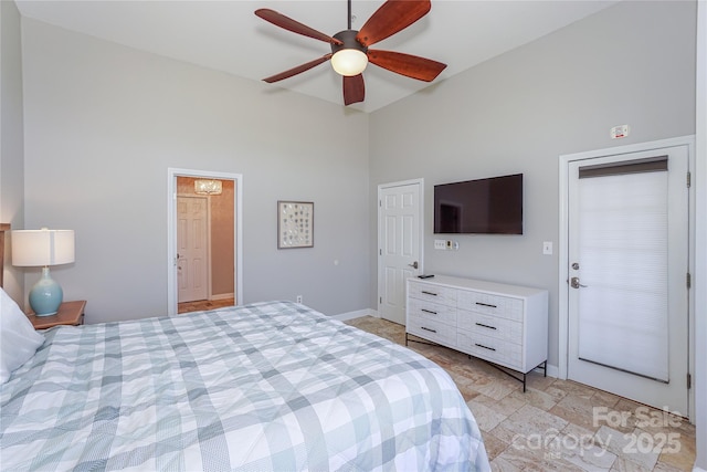 bedroom with stone finish floor, baseboards, high vaulted ceiling, and a ceiling fan