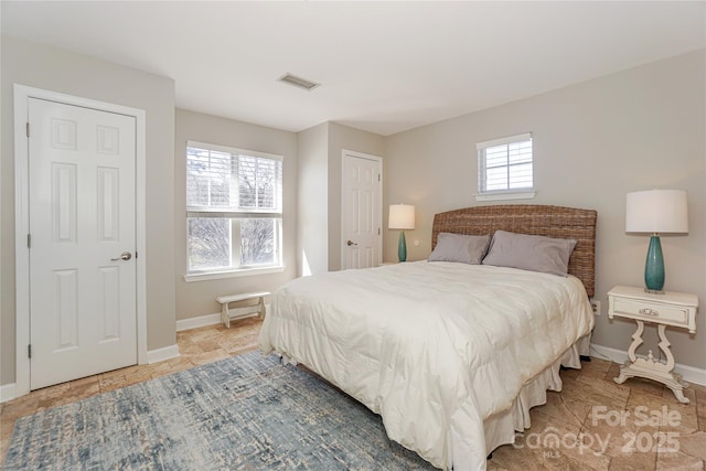 bedroom with visible vents and baseboards