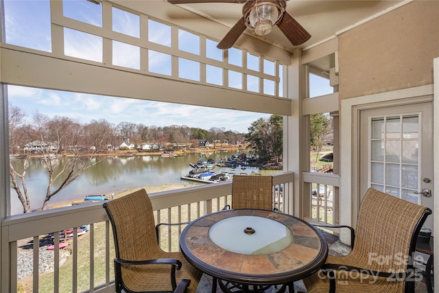 exterior space with a water view and ceiling fan