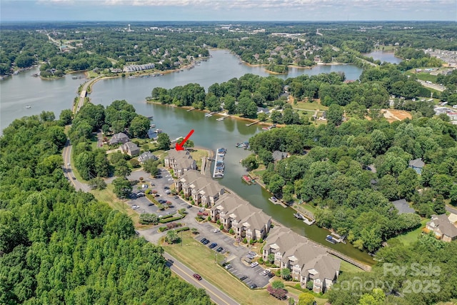 bird's eye view featuring a forest view and a water view