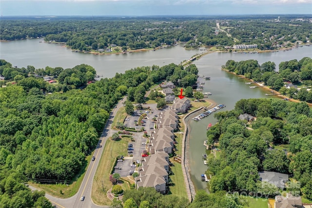 birds eye view of property with a water view and a view of trees