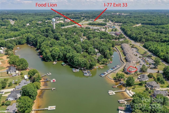 bird's eye view featuring a water view and a wooded view