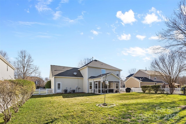 back of property featuring a fenced backyard, central AC, a yard, and a sunroom