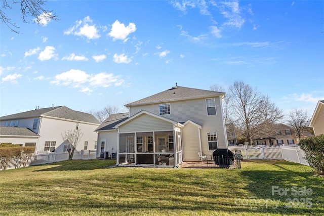 back of house with a yard, central AC, a fenced backyard, and a sunroom