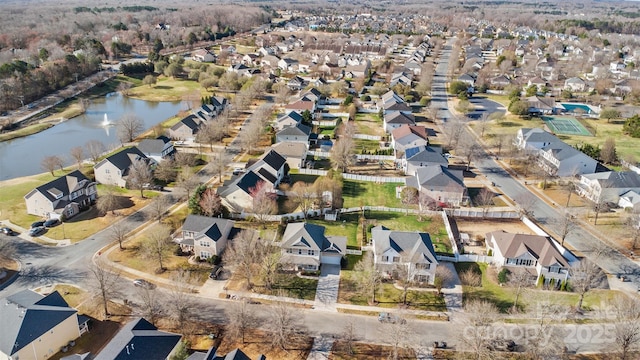 birds eye view of property with a residential view and a water view