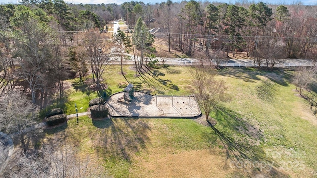 birds eye view of property with a view of trees