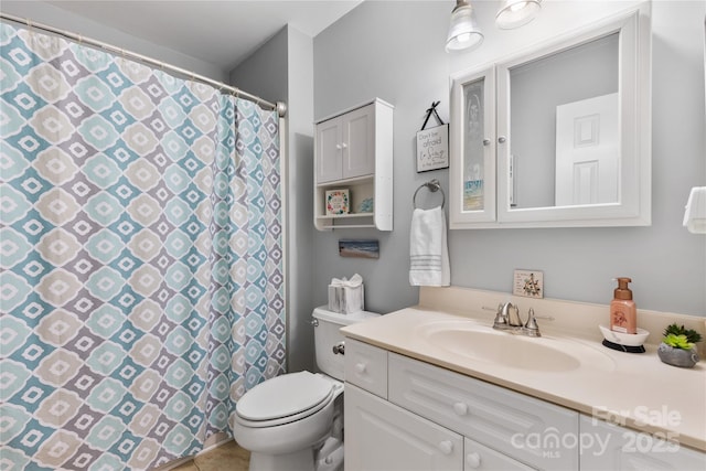 full bathroom with vanity, curtained shower, and toilet