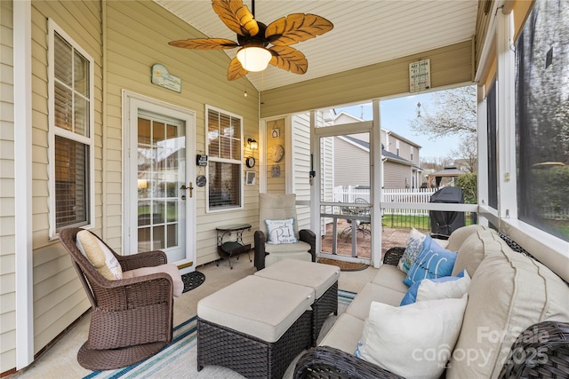 sunroom with a wealth of natural light, a ceiling fan, and vaulted ceiling