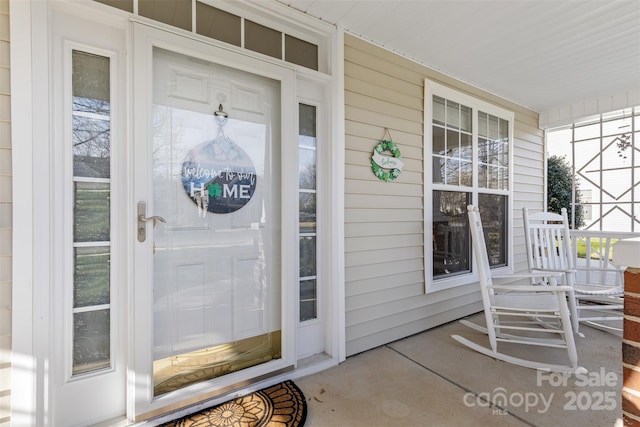 view of exterior entry featuring a porch