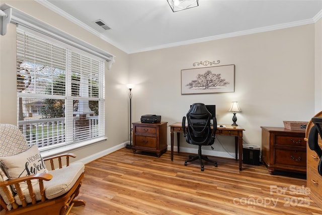 office featuring baseboards, light wood-style floors, visible vents, and ornamental molding