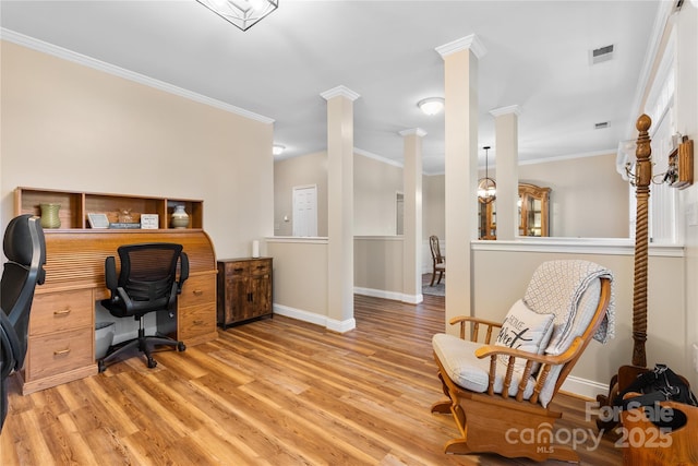 office space featuring decorative columns, visible vents, ornamental molding, and light wood finished floors