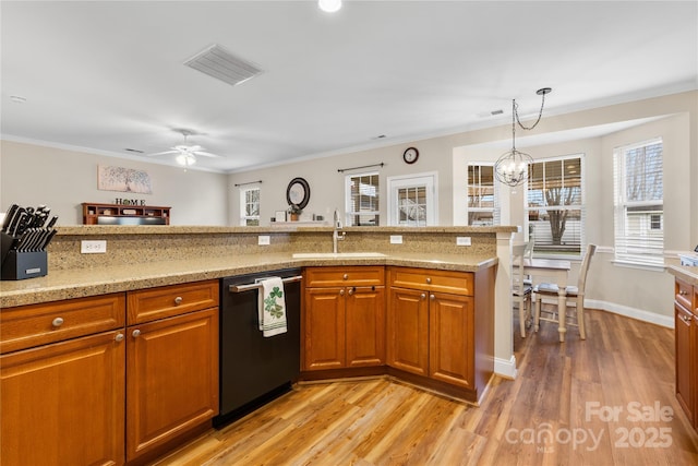 kitchen with dishwashing machine, visible vents, light wood finished floors, a sink, and brown cabinets