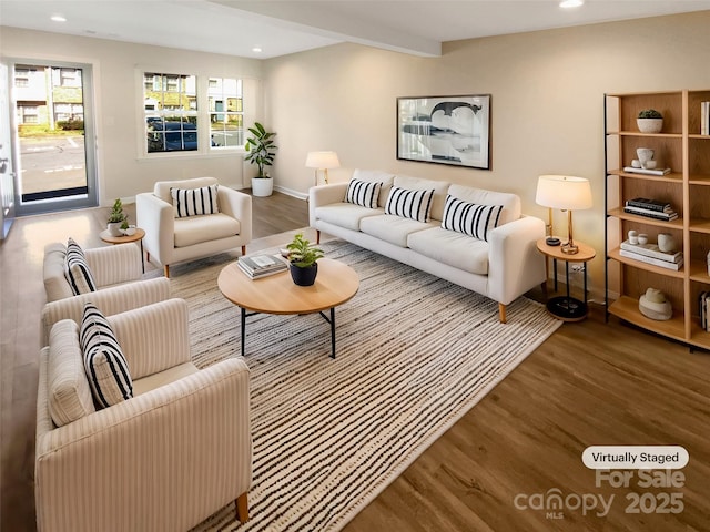 living room with recessed lighting, beam ceiling, a healthy amount of sunlight, and wood finished floors