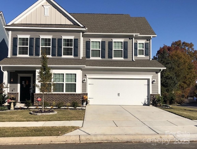 view of front of property with board and batten siding, an attached garage, concrete driveway, and brick siding