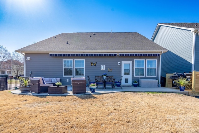 rear view of house with a patio, fence, roof with shingles, an outdoor living space, and a yard