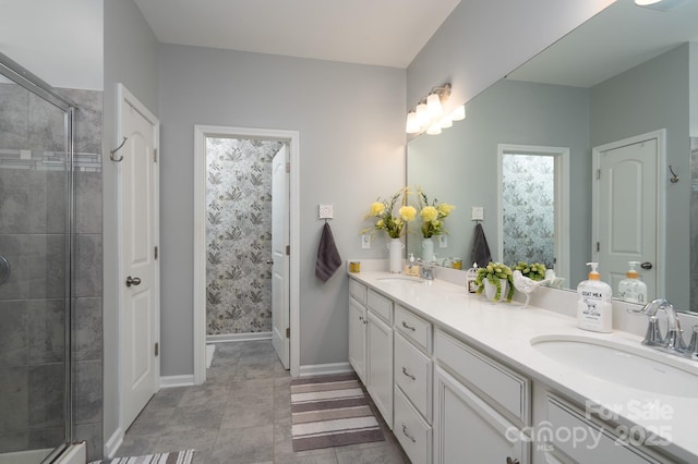 126 W Morehouse Ave, Mooresville, NC 28117 - bathroom with baseboards, double vanity, a sink, and a shower stall