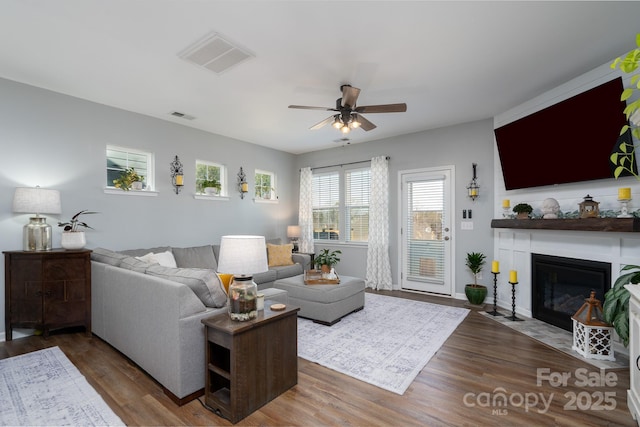126 W Morehouse Ave, Mooresville, NC 28117 - living room with a fireplace with flush hearth, visible vents, wood finished floors, and a ceiling fan