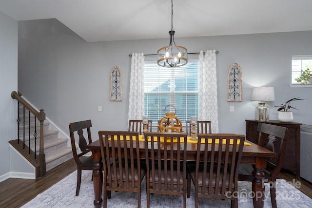 126 W Morehouse Ave, Mooresville, NC 28117 - dining space with baseboards, stairs, wood finished floors, and an inviting chandelier