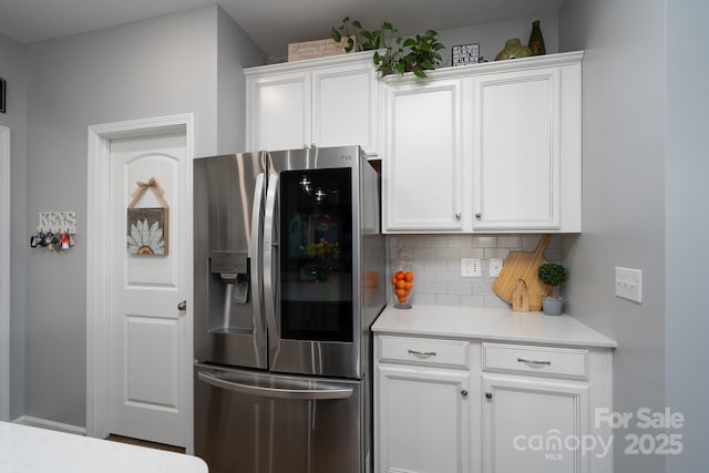 126 W Morehouse Ave, Mooresville, NC 28117 - kitchen with backsplash, light countertops, stainless steel fridge, and white cabinets