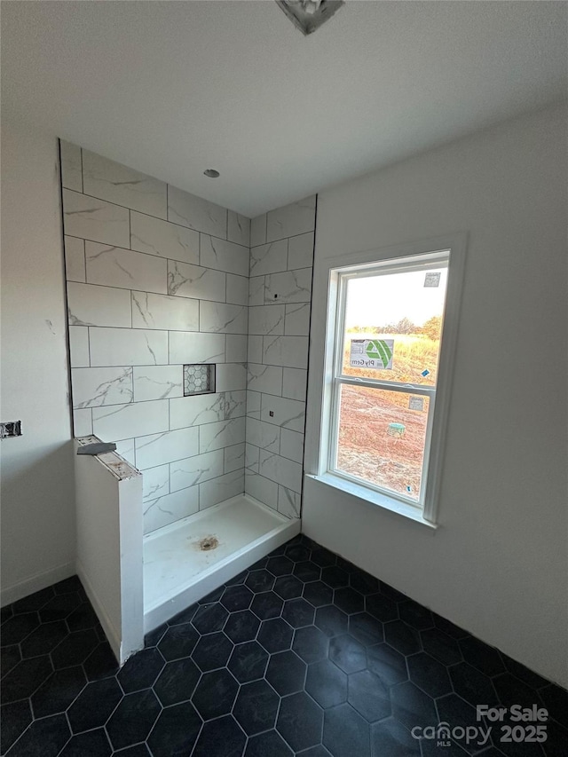 full bathroom featuring tiled shower