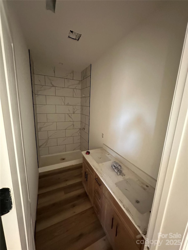 full bath with a shower stall and wood finished floors